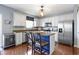 Eat-in kitchen with white cabinets, stainless steel appliances, and a center island at 5593 Ralfe Rd, Indianapolis, IN 46234