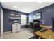 Bright, comfortable office space with blue walls, built-in desk, and lots of light at 5593 Ralfe Rd, Indianapolis, IN 46234