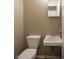 Functional vintage bathroom with toilet, sink, and mirror for essential needs and convenience at 5605 Glencoe St, Indianapolis, IN 46226
