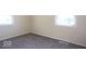 Empty bedroom with carpeting and two windows allowing lots of natural light to brighten the space at 5605 Glencoe St, Indianapolis, IN 46226