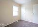 A cozy carpeted bedroom with natural light, adjacent to a storage closet space at 5605 Glencoe St, Indianapolis, IN 46226