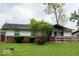 Quaint single-story house featuring a brick foundation and a large, grassy front lawn at 5605 Glencoe St, Indianapolis, IN 46226