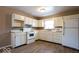 Well-lit kitchen featuring white appliances, matching cabinets, and contemporary flooring at 5605 Glencoe St, Indianapolis, IN 46226