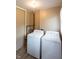 Bright laundry room featuring a side-by-side washer and dryer for convenient chores at 5605 Glencoe St, Indianapolis, IN 46226