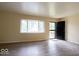 Bright living room featuring new floors, and a view of the front yard through large windows at 5605 Glencoe St, Indianapolis, IN 46226