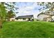 Level backyard features mature trees and a well-manicured lawn at 5611 Burning Tree Ct, Indianapolis, IN 46239