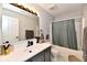 Modern bathroom featuring a gray vanity with a white countertop, tub, and hexagon tile floor at 5611 Burning Tree Ct, Indianapolis, IN 46239