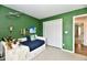 Bright bedroom featuring green walls, a daybed with trundle storage, and playful decor at 5611 Burning Tree Ct, Indianapolis, IN 46239