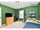 This bedroom features a wooden dresser, a window with curtains and unique airplane themed decorations at 5611 Burning Tree Ct, Indianapolis, IN 46239