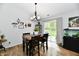 Inviting dining area with sliding glass door, chandelier, and a view of the outdoors at 5611 Burning Tree Ct, Indianapolis, IN 46239