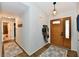 Inviting entryway with hardwood floors, modern lighting, and a decorative front door at 5611 Burning Tree Ct, Indianapolis, IN 46239