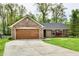Brick home with a well-kept lawn and attached garage at 5611 Burning Tree Ct, Indianapolis, IN 46239