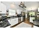 Modern kitchen with white cabinets, black marble countertops, and stainless steel appliances at 5611 Burning Tree Ct, Indianapolis, IN 46239
