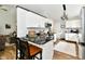 Elegant kitchen with white cabinets, black countertops, and barstool seating at the counter at 5611 Burning Tree Ct, Indianapolis, IN 46239