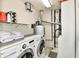 Functional laundry room equipped with a washer, dryer, shelving and utility equipment at 5611 Burning Tree Ct, Indianapolis, IN 46239