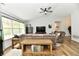 Comfortable living room with wood floors, ceiling fan, and lots of natural light at 5611 Burning Tree Ct, Indianapolis, IN 46239
