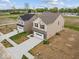 Aerial view of charming homes featuring brick and siding, complemented by a spacious two-car garage and green lawns at 564 Plowman Dr, Shelbyville, IN 46176