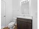 Well-lit half bath featuring a dark vanity with marble countertop, and chrome faucet at 564 Plowman Dr, Shelbyville, IN 46176