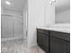 Bathroom view showcasing double vanity, modern lighting, and a glass-enclosed shower at 564 Plowman Dr, Shelbyville, IN 46176