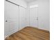Bright entryway with wood-look floors, coat closet, and access door to the attached garage for easy entry at 564 Plowman Dr, Shelbyville, IN 46176