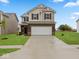 Charming two-story home featuring brick and siding, complemented by a spacious two-car garage and manicured lawn at 564 Plowman Dr, Shelbyville, IN 46176
