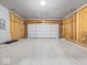 An unfinished garage with an insulated garage door at 564 Plowman Dr, Shelbyville, IN 46176