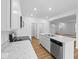 Bright kitchen featuring white cabinets, stainless steel appliances, and a center island with a marble countertop at 564 Plowman Dr, Shelbyville, IN 46176