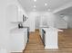 Bright kitchen featuring white cabinets, stainless steel appliances, and a center island with a marble countertop at 564 Plowman Dr, Shelbyville, IN 46176