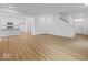 Inviting living area featuring wood-look floors, bright white walls, and an open layout at 564 Plowman Dr, Shelbyville, IN 46176
