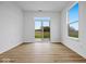 Bright living room with sliding glass doors and light wood flooring, offering a seamless indoor-outdoor flow at 564 Plowman Dr, Shelbyville, IN 46176