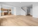 Spacious living room with wood-look floors, white walls, and an open floor plan, perfect for entertaining at 564 Plowman Dr, Shelbyville, IN 46176