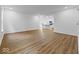 Open-concept living area with wood-look floors, white walls, and seamless flow to the kitchen at 564 Plowman Dr, Shelbyville, IN 46176