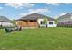 Spacious backyard featuring a covered patio and fire pit area, great for outdoor entertaining and relaxation at 5667 Skylark Dr, Greenwood, IN 46143