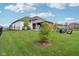 Expansive backyard featuring a covered patio, fire pit, and lush green lawn, ideal for outdoor gatherings and relaxation at 5667 Skylark Dr, Greenwood, IN 46143