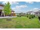 Lush backyard with covered patio, outdoor seating, and fire pit, perfect for enjoying the outdoors and entertaining at 5667 Skylark Dr, Greenwood, IN 46143