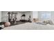 Wide angle view of finished basement featuring workout equipment, play area, and a large window at 5667 Skylark Dr, Greenwood, IN 46143