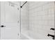 Bathroom showcasing a tiled shower, a shower head, and a white door at 5667 Skylark Dr, Greenwood, IN 46143
