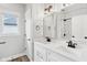 Modern bathroom featuring dual sinks, white cabinets, a window, and a tiled shower at 5667 Skylark Dr, Greenwood, IN 46143