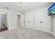 A clean bedroom space featuring three closets, television, carpet, and great natural light at 5667 Skylark Dr, Greenwood, IN 46143