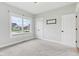 Bright bedroom featuring neutral carpet, a large window with neighborhood views, and white trim at 5667 Skylark Dr, Greenwood, IN 46143