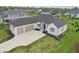 Aerial view of a beautiful home with a three-car garage, well-manicured lawn, and attractive landscaping at 5667 Skylark Dr, Greenwood, IN 46143