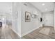 Hallway featuring a wood floor, light gray walls, and decorative wall art at 5667 Skylark Dr, Greenwood, IN 46143
