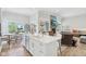 Bright open-concept kitchen with white cabinets, island, hardwood floors, and stainless steel appliances at 5667 Skylark Dr, Greenwood, IN 46143