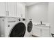 Laundry room featuring white cabinets, a sink, and a front load washer and dryer at 5667 Skylark Dr, Greenwood, IN 46143