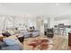 Bright, open living room featuring luxury vinyl plank flooring and views into the kitchen at 5667 Skylark Dr, Greenwood, IN 46143
