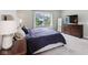 Comfortable main bedroom with a large window, a modern dresser, and plush carpet at 5667 Skylark Dr, Greenwood, IN 46143
