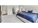 Spacious main bedroom features a plush carpet, a large window, upholstered headboard, and ensuite bathroom at 5667 Skylark Dr, Greenwood, IN 46143