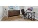 Home office showcasing a wood floor, a wood dresser, and a desk with a computer at 5667 Skylark Dr, Greenwood, IN 46143