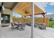 Relaxing covered patio with a ceiling fan, dining table, and lounge seating, perfect for outdoor enjoyment at 5667 Skylark Dr, Greenwood, IN 46143