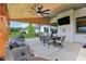 Comfortable covered patio featuring a ceiling fan, dining area, and cozy seating for outdoor relaxation and entertaining at 5667 Skylark Dr, Greenwood, IN 46143